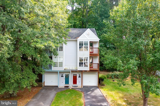 townhome / multi-family property featuring a balcony and a garage