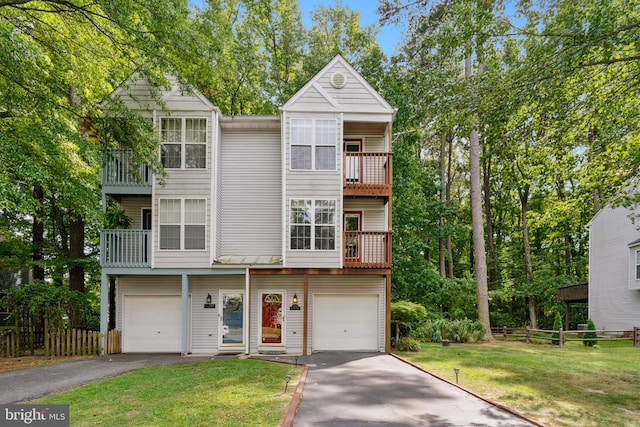 multi unit property with a balcony, a garage, and a front yard