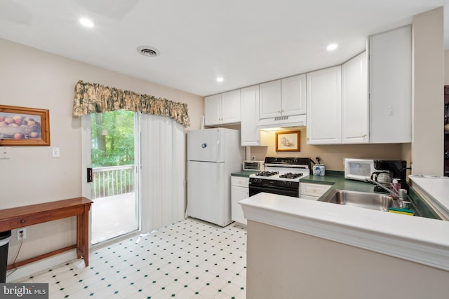 kitchen with sink, white appliances, and white cabinetry