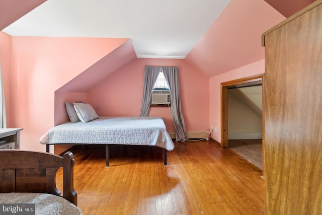 bedroom with cooling unit, a baseboard heating unit, light wood-type flooring, and lofted ceiling