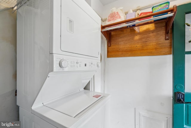 clothes washing area with stacked washer / drying machine