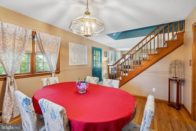 dining room with an inviting chandelier and hardwood / wood-style flooring