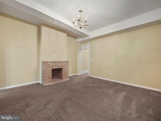 unfurnished living room featuring a brick fireplace, a chandelier, and carpet flooring