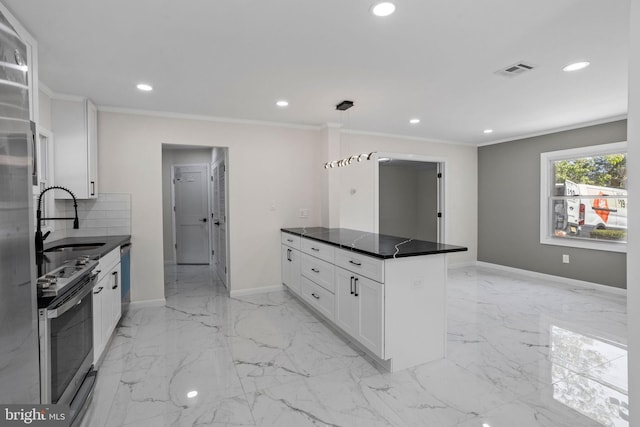 kitchen featuring ornamental molding, white cabinetry, stainless steel appliances, sink, and decorative backsplash