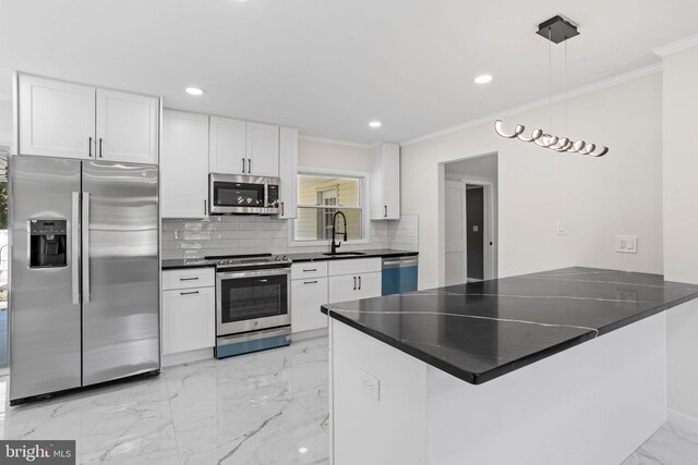 kitchen featuring appliances with stainless steel finishes, kitchen peninsula, backsplash, and white cabinetry