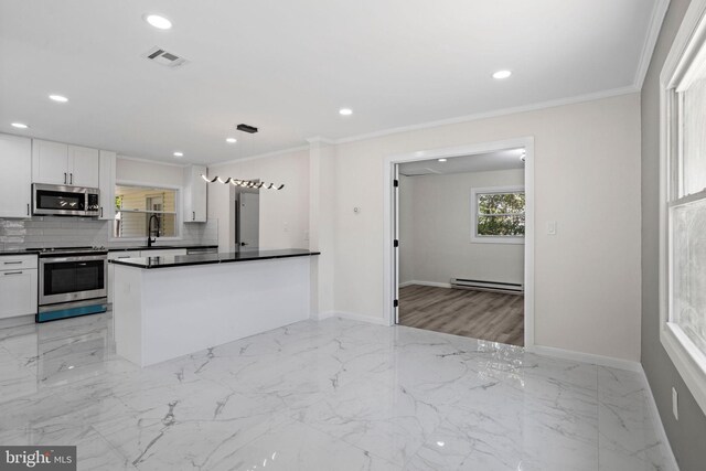 kitchen with crown molding, white cabinetry, tasteful backsplash, decorative light fixtures, and stainless steel appliances