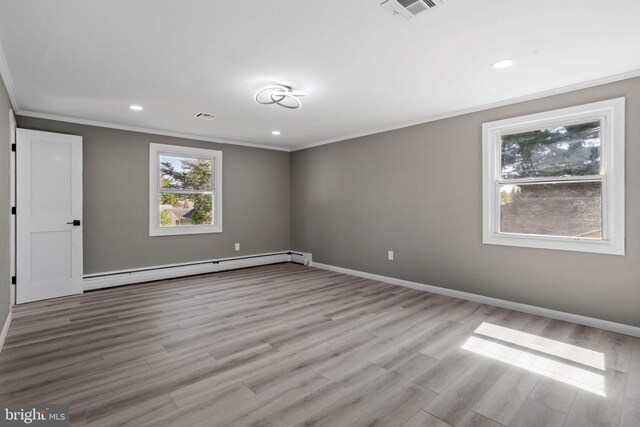 unfurnished room featuring ornamental molding, a baseboard radiator, and light hardwood / wood-style floors