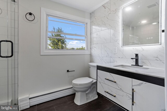 bathroom featuring vanity, an enclosed shower, tile walls, toilet, and baseboard heating