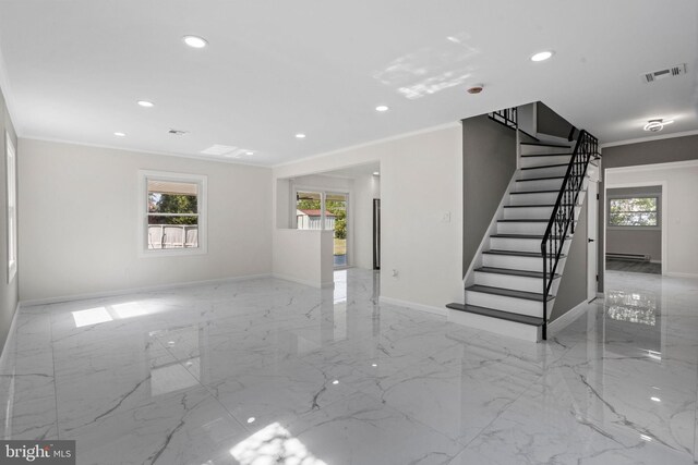 unfurnished room with crown molding, a healthy amount of sunlight, and a baseboard radiator