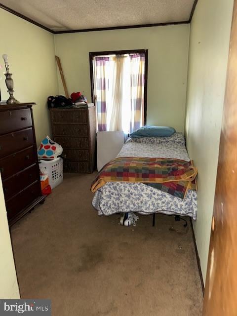 bedroom featuring a textured ceiling and carpet