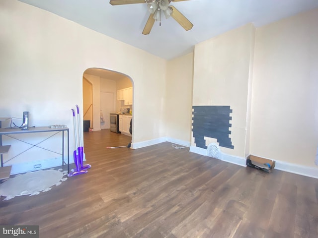 living room featuring ceiling fan and dark hardwood / wood-style flooring