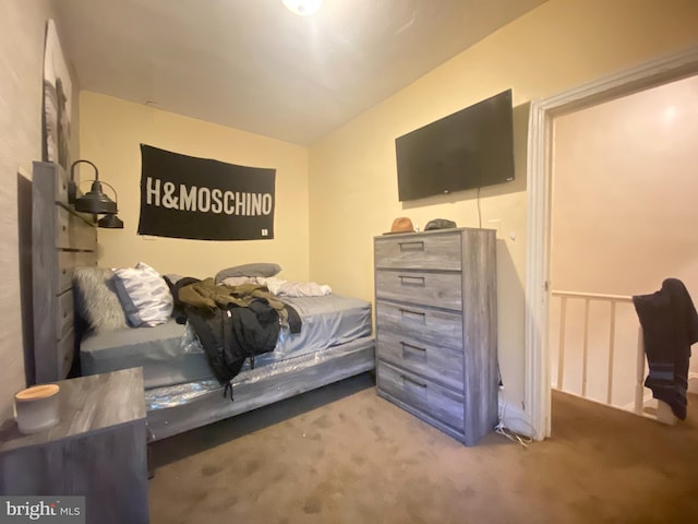 carpeted bedroom featuring lofted ceiling