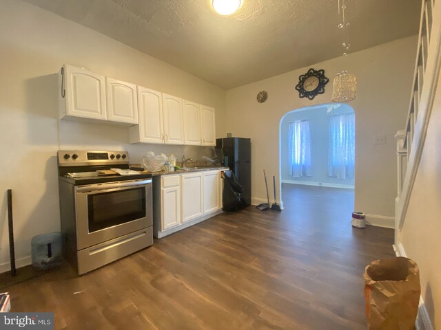 kitchen with stainless steel electric range oven, white cabinets, sink, dark hardwood / wood-style floors, and a textured ceiling