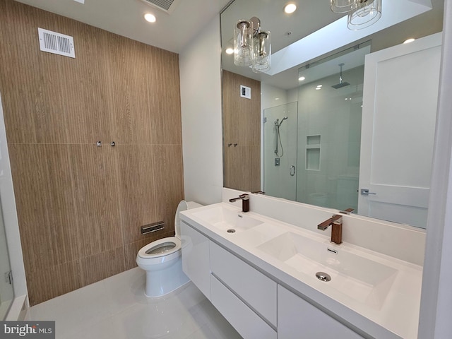 bathroom with vanity, an inviting chandelier, tile patterned floors, toilet, and a shower with shower door