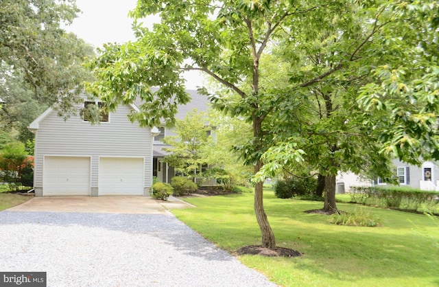 view of front facade with a garage and a front lawn