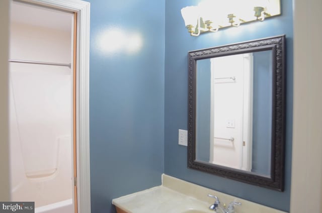 bathroom with vanity and a washtub