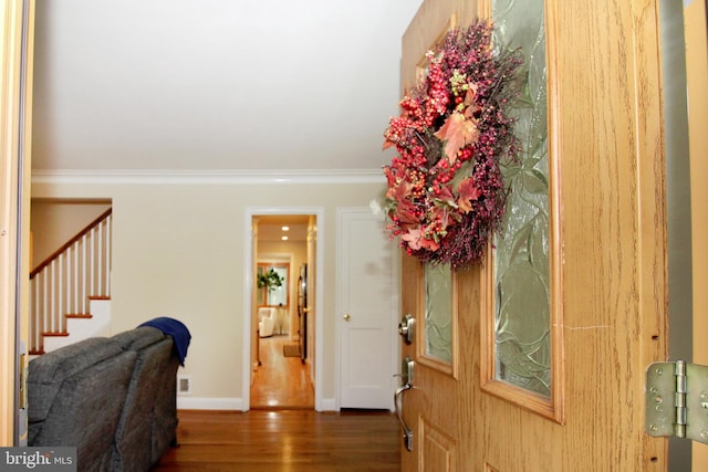 foyer featuring crown molding and dark hardwood / wood-style flooring