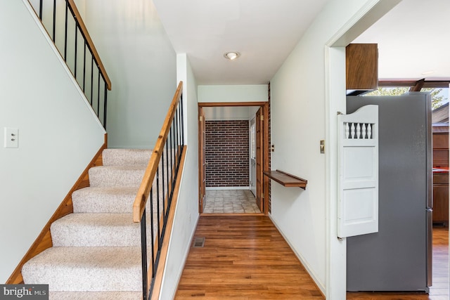 stairway featuring hardwood / wood-style floors