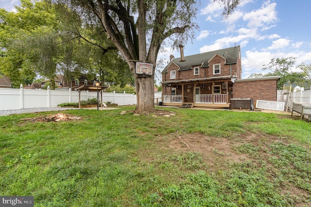 rear view of property featuring a deck and a yard