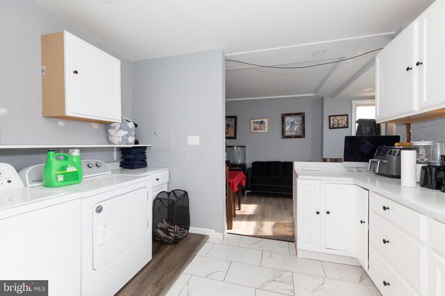 laundry room with washer and clothes dryer and light hardwood / wood-style floors