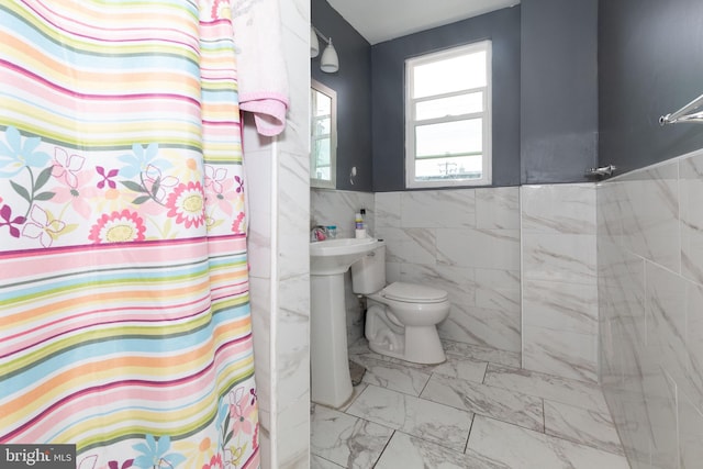 3000 N 24th St, Philadelphia, PA 19132 - full bathroom with a shower with curtain, tile walls, toilet, and marble finish floor