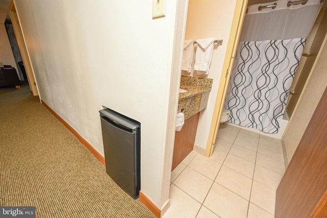 hall featuring light tile patterned floors