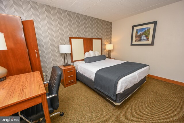 bedroom featuring dark carpet