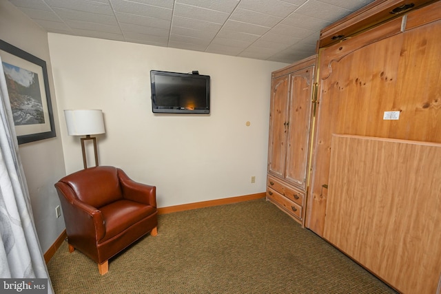 sitting room featuring dark colored carpet