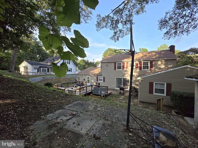 back of house with a wooden deck