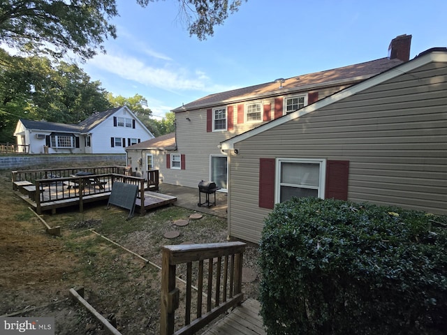 rear view of property featuring a deck