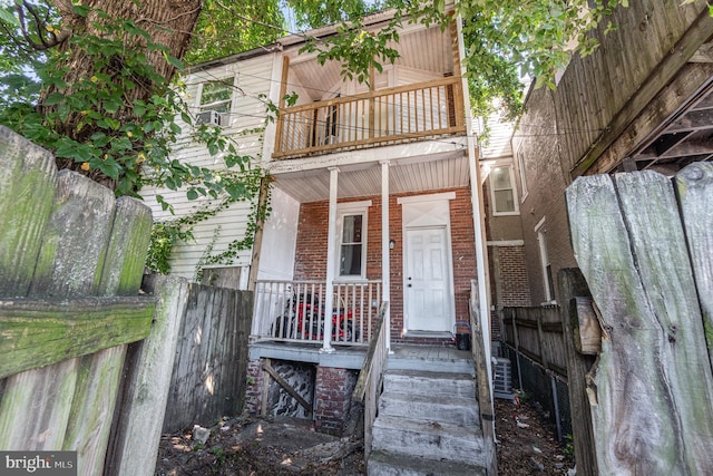 view of front of house featuring a balcony