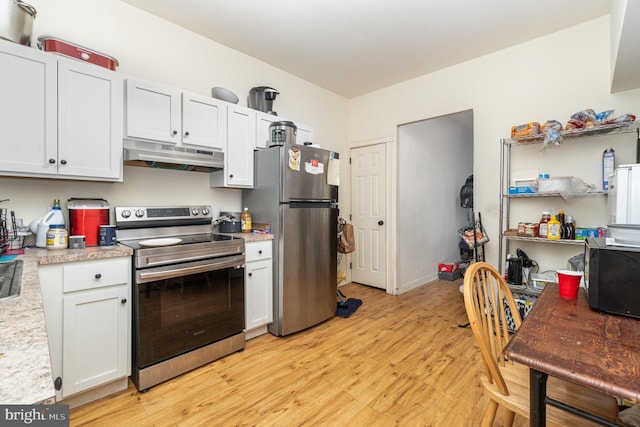 kitchen with appliances with stainless steel finishes, light hardwood / wood-style flooring, and white cabinets