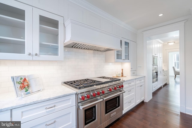 kitchen with white cabinetry, appliances with stainless steel finishes, dark hardwood / wood-style floors, and custom range hood