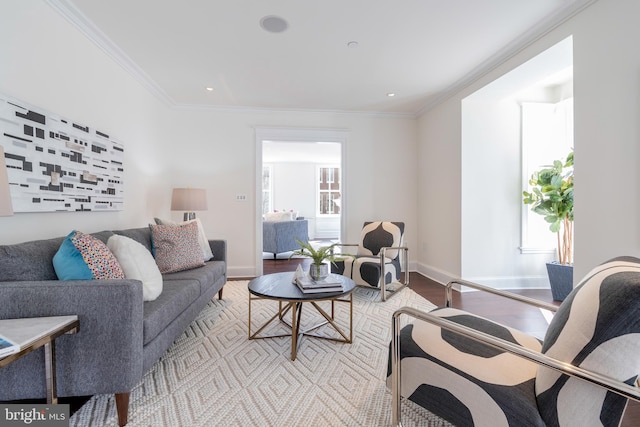 living room with light wood-type flooring and ornamental molding