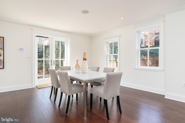 dining room with ornamental molding and dark hardwood / wood-style flooring