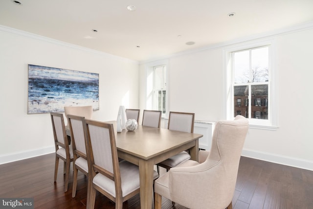 dining room featuring crown molding and dark hardwood / wood-style flooring