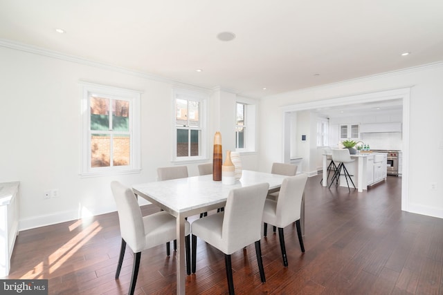 dining space featuring crown molding and dark hardwood / wood-style flooring