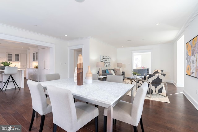 dining room with crown molding and dark wood-type flooring