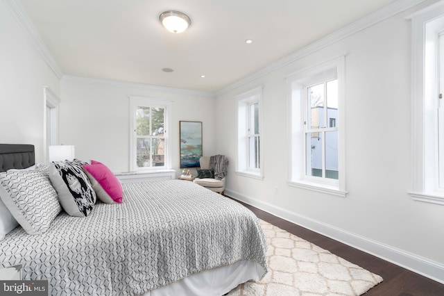 bedroom with dark hardwood / wood-style floors and ornamental molding