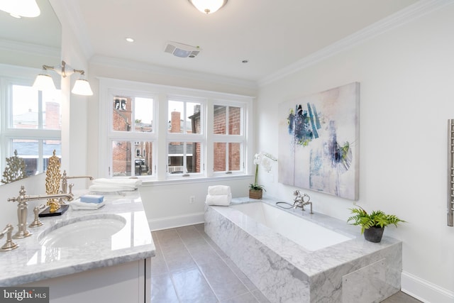 bathroom featuring a relaxing tiled tub, vanity, crown molding, and tile patterned floors