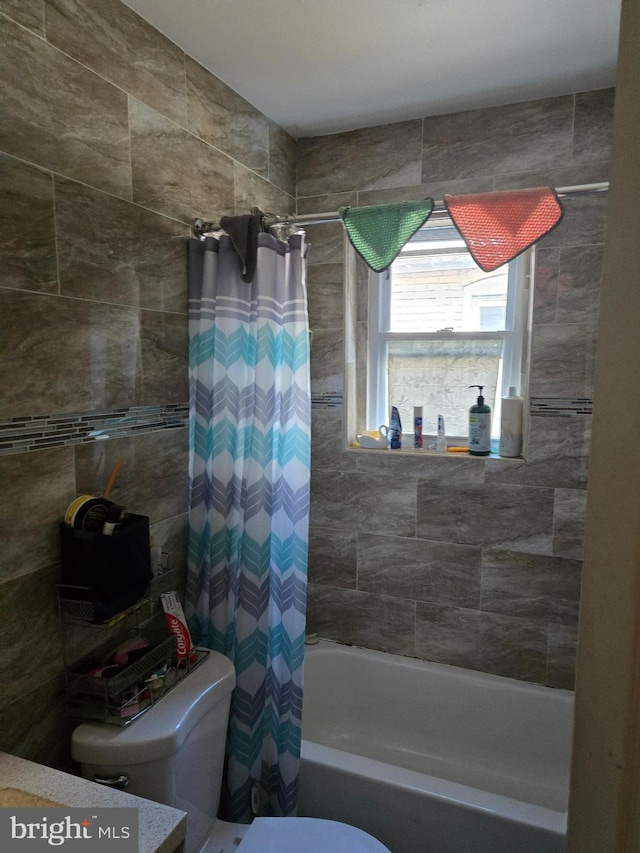 bathroom featuring toilet and shower / tub combo with curtain