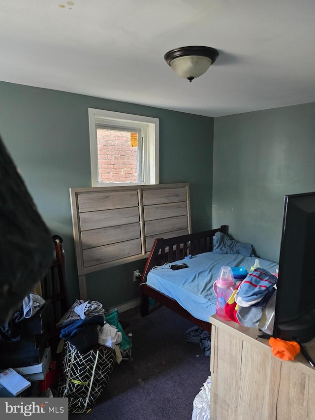 bedroom featuring dark carpet