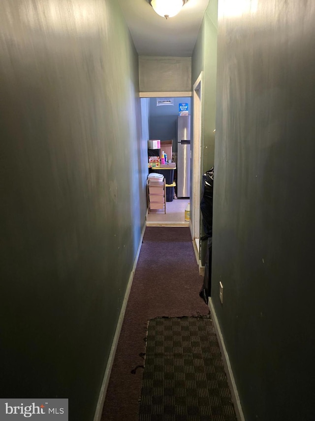 hallway featuring dark carpet