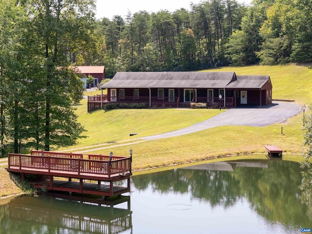 dock area with a water view and a lawn