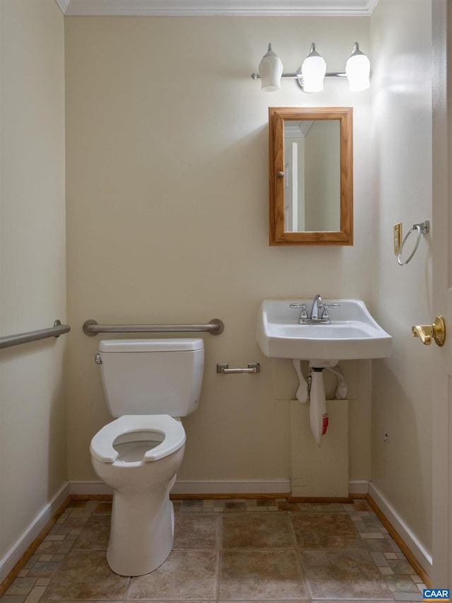 bathroom with crown molding, toilet, and sink