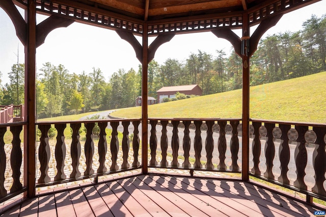 wooden deck featuring a lawn