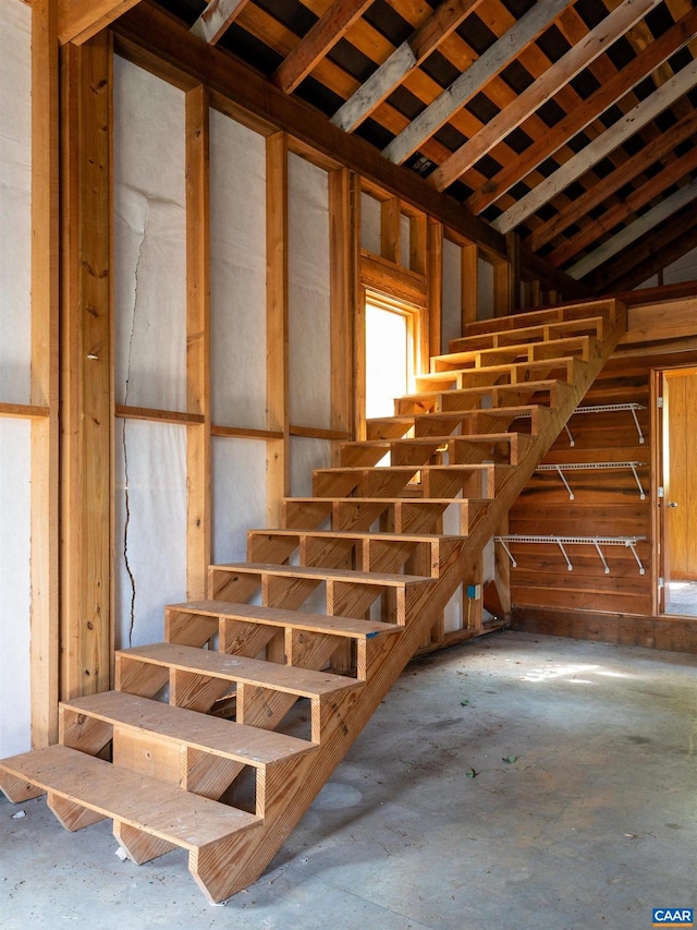 staircase featuring concrete flooring