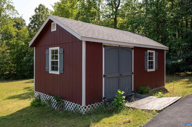 view of outbuilding with a yard