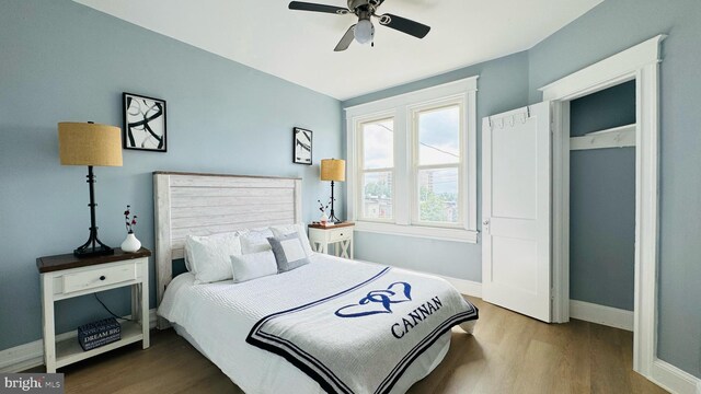 bedroom with ceiling fan and hardwood / wood-style flooring