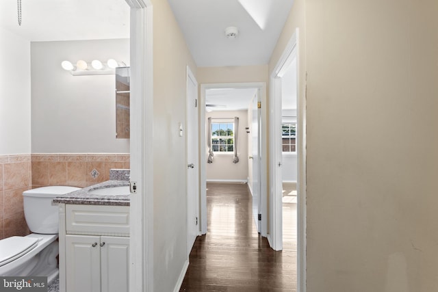 interior space featuring tile walls, dark hardwood / wood-style floors, and sink